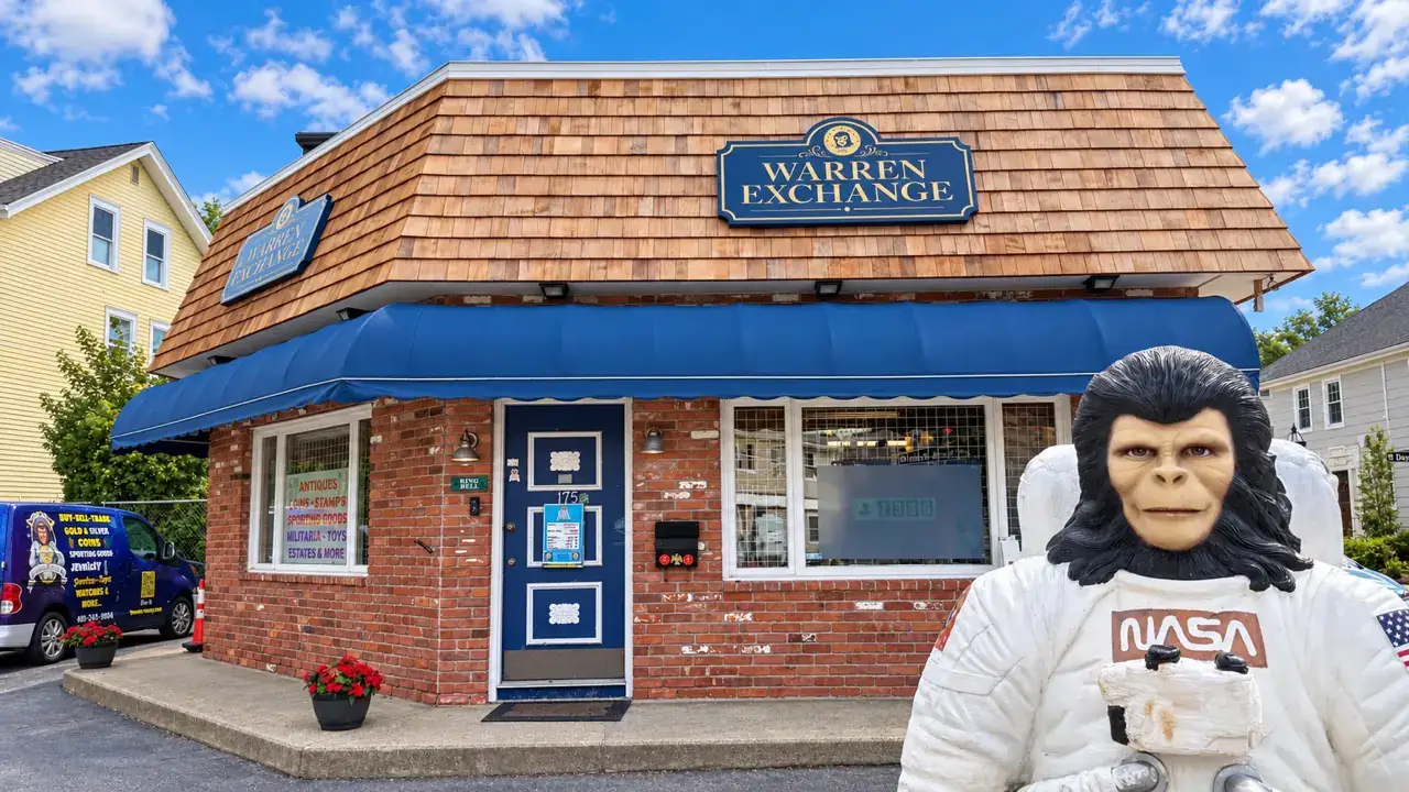 The Warren Exchange storefront at 175 Main Street in Warren, Rhode Island, with Zippy the space monkey standing out front.