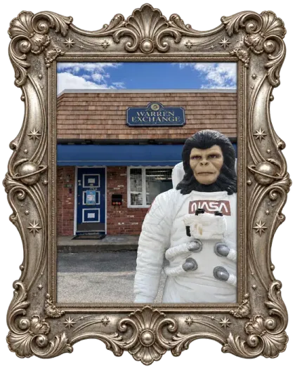 Zippy, Warren Exchange's space-monkey mascot, standing by the front door.